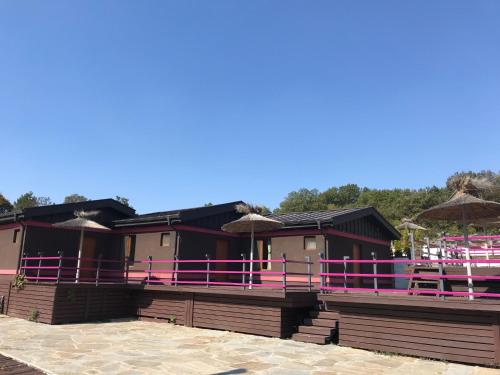 a resort with pink and purple railing on a building at Elinor Complex in Haskovo
