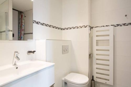 une salle de bain blanche avec des toilettes et un lavabo dans l'établissement MARRIOTT : 2 BEDS/2 BATHS SEA VIEW, à Cannes