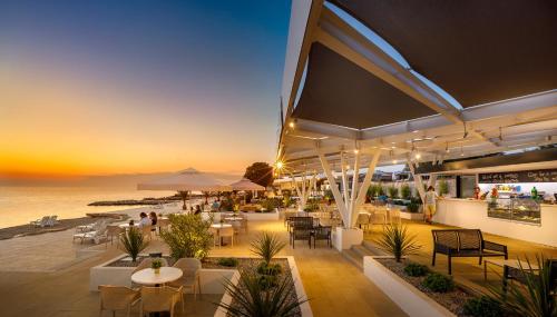 a restaurant with a view of the ocean at sunset at Aminess Planet Camping Holiday Homes Maravea in Novigrad Istria
