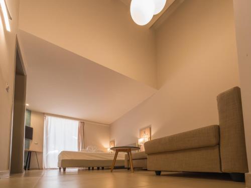 a living room with a couch and a bed at Paradise Resort in Finikounta