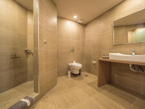 a bathroom with a sink and a toilet at Paradise Resort in Finikounta