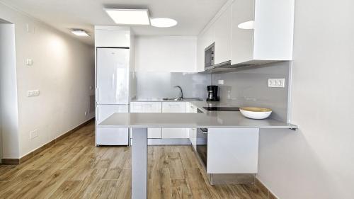 a kitchen with white cabinets and a counter top at Las Nasas by Labranda in Playa del Ingles