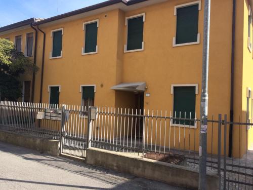 a yellow building with a fence in front of it at Portello in Padova