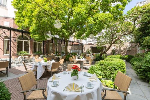 a table set up in front of a garden at Stanhope Hotel by Thon Hotels in Brussels