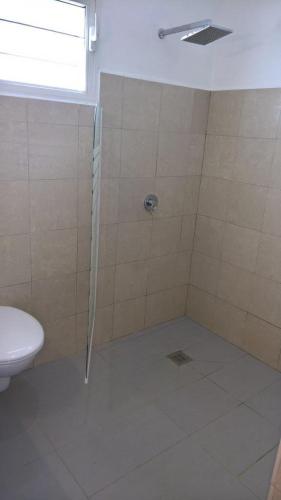 a bathroom with a shower and a toilet at Savane Paille in Deshaies