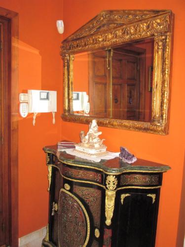 a mirror on a wall next to a table at La Torre del Indiano-Villa- in Santander