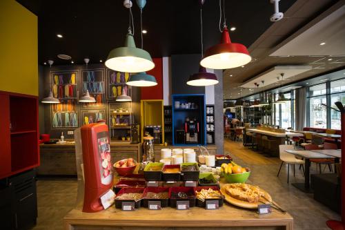 a restaurant with a buffet of food on a table at ibis Vilnius Centre in Vilnius