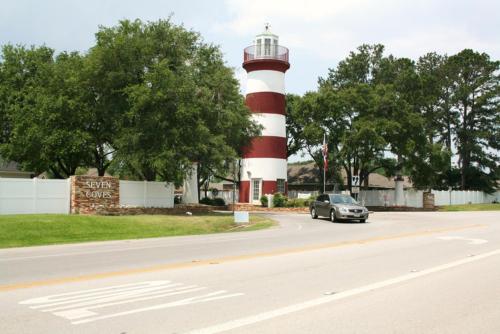 a car driving past a red and white lighthouse at Resort Attractions in Willis