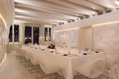 a large dining room with white tables and chairs at Sina Centurion Palace in Venice
