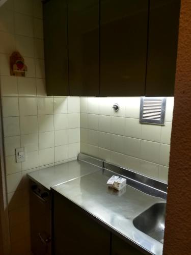 a kitchen counter with a sink and a mirror at Playa Club Argentina in Miramar
