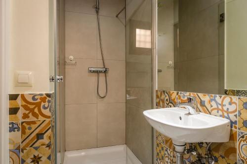 a bathroom with a sink and a shower at YIT Puerta Bisagra in Toledo
