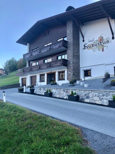 a building with a road in front of it at Haus Hubertus Sommerpreise incl Sommercard in Jerzens