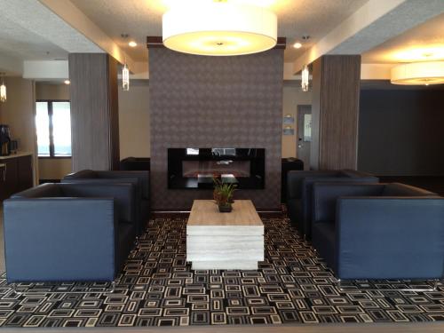 a lobby with couches and a table and a fireplace at Days Inn & Suites by Wyndham Yorkton in Yorkton