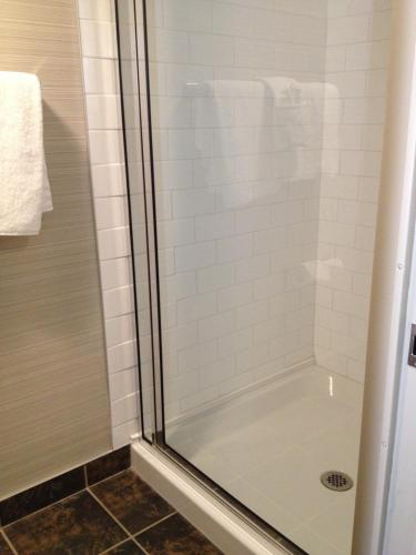 a shower in a bathroom with a glass shower stall at Days Inn & Suites by Wyndham Yorkton in Yorkton