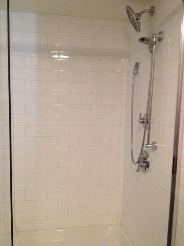 a bathroom with a shower with a glass door at Days Inn & Suites by Wyndham Yorkton in Yorkton