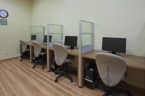 an office with a row of desks with computer monitors at Radisson Hotel Panama Canal in Panama City