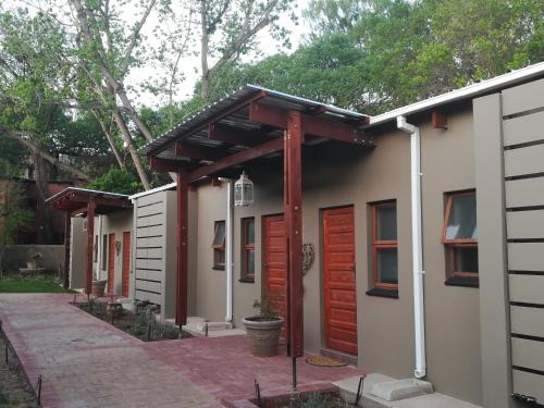 a row of houses with red doors on them at Tranquil House B&B @ 121 Berry St in Queenstown