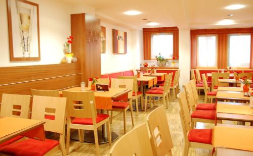 a restaurant with tables and chairs in a room at Schell Schokoladen in Gundelsheim