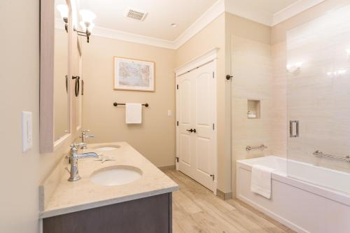 a bathroom with a sink and a tub and a toilet at SookePoint Ocean Cottage Resort in Sooke
