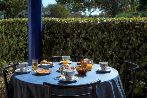 a blue table with food and drinks on it at Audotel in Carcassonne