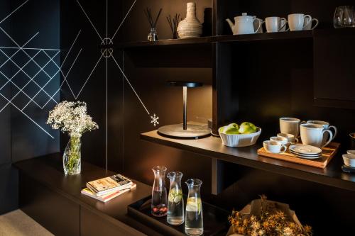 a table with a vase of flowers on a shelf at Casa de São Lourenço - Burel Panorama Hotel - member of Design Hotels in Manteigas