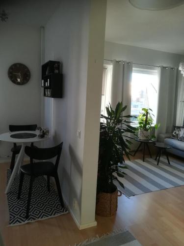 a living room with a table and two chairs and a table at Nordic Home, with private sauna, free parking in Rovaniemi