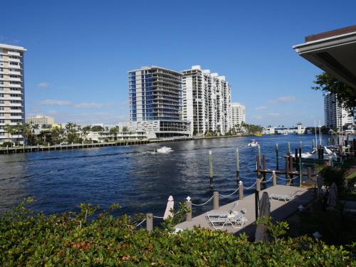 a view of a river with buildings in the background at Holiday Isle Yacht Club in Fort Lauderdale