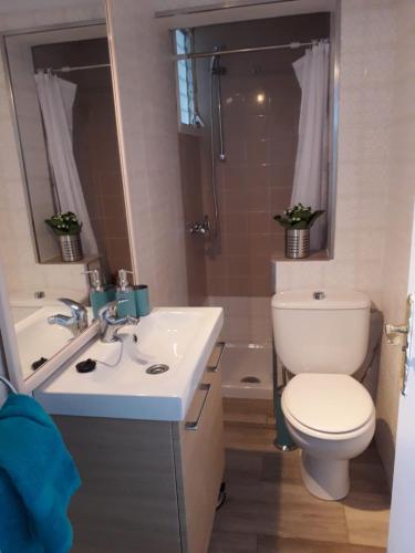 a bathroom with a toilet and a sink and a shower at Casa Trini in La Mareta