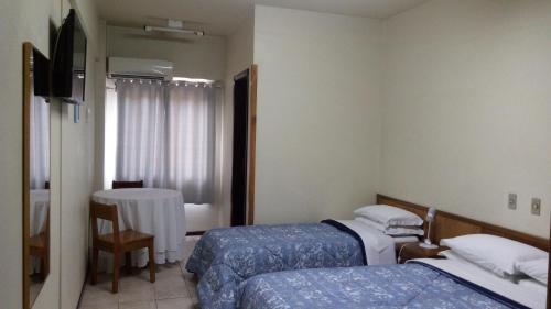 Hotel Panorama tesisinde bir odada yatak veya yataklar