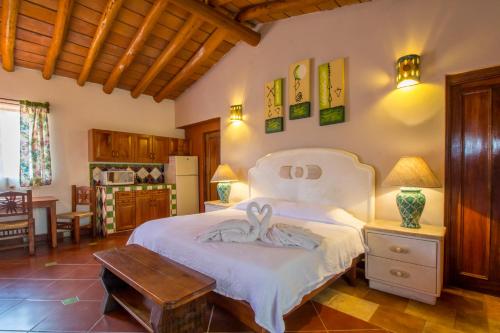 1 dormitorio con 1 cama grande y 1 mesa en Casa Virgilios B&B, en Nuevo Vallarta 