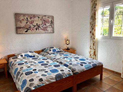a bedroom with a bed with a blue and white comforter at Casita Vista Valle 35 in El Paso