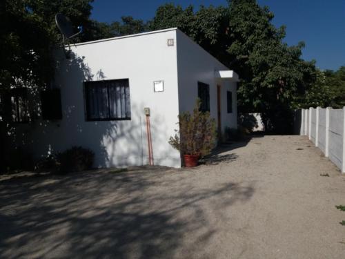 a white building with a fence in front of it at Apartamento La Calera in La Calera
