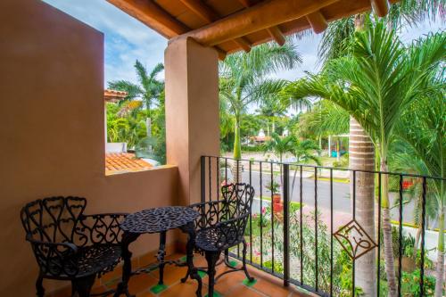 a patio area with chairs, a bench, and a walkway at Casa Virgilios B&B in Nuevo Vallarta