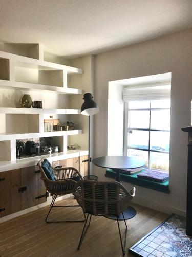 a living room with a table and chairs and a window at B&B No. 42 in Valkenburg