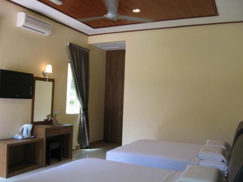 Ένα ή περισσότερα κρεβάτια σε δωμάτιο στο New Dawn for Langkawi