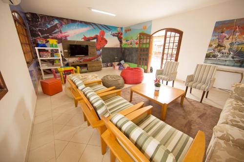 a living room with a bunch of couches and a table at Elite Hotel in Florianópolis