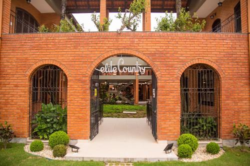a brick building with two entrances to a store at Elite Hotel in Florianópolis