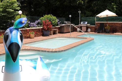 a swimming pool with a inflatable whale in the water at Mt Tamborine Motel in Mount Tamborine