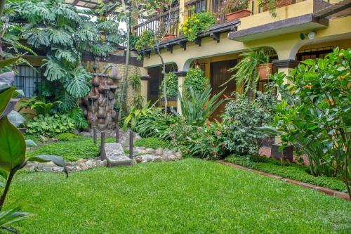 a garden in front of a house at Hotel Las Camelias Inn by AHS in Antigua Guatemala