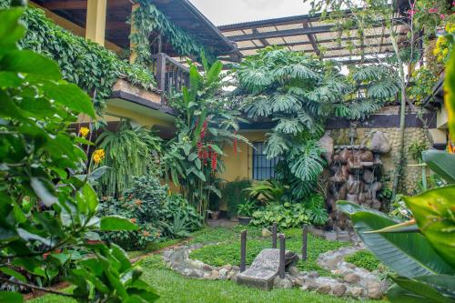 a garden in front of a building at Hotel Las Camelias Inn by AHS in Antigua Guatemala