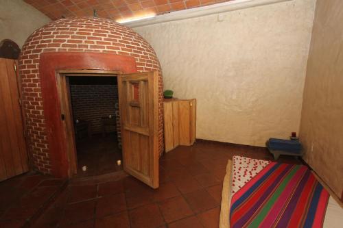 a small room with a brick wall and a door at Hotel Boutique Casa Catrina in Oaxaca City