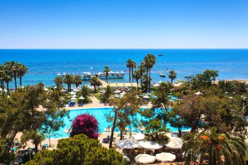 a view of a resort with a pool and the ocean at Turquoise Hotel in Side