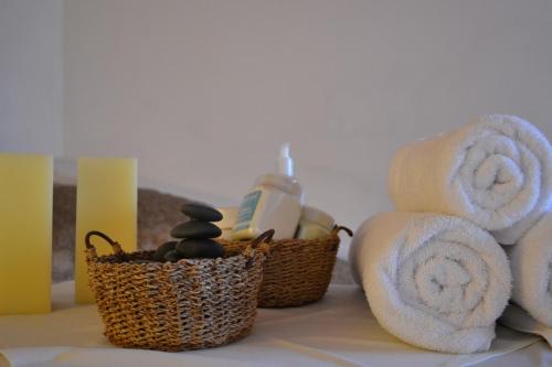 a bathroom counter with towels and a basket of soap at Tagore Suites Hotel in Villa Carlos Paz