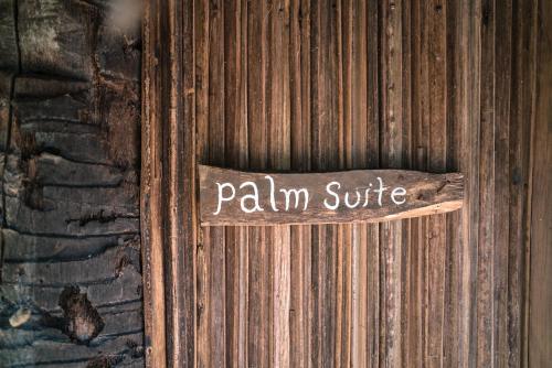 a wooden door with a sign that reads palimsie at Utopia Rote Lodge in Nembrala