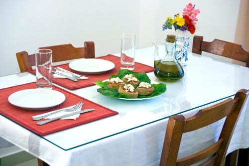 a white table with a plate of food on it at Garifalo Apartments in Kalyves