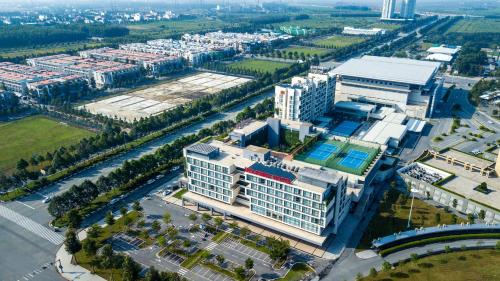 an aerial view of a building with a pool at Becamex Hotel New City in Thu Dau Mot