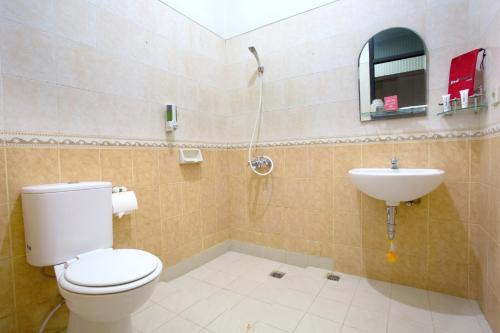 a bathroom with a toilet and a sink at RedDoorz @ Surapati in Bandung