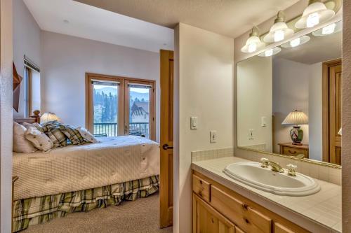 um quarto com uma cama, um lavatório e um espelho em L306 Kirkwood Lodge em Kirkwood