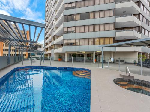 a large swimming pool in a large building at The Astor Apartments in Brisbane