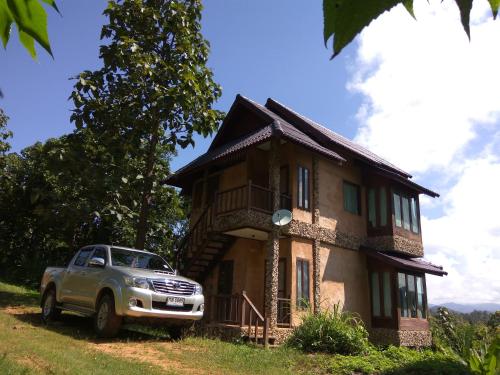 a car parked in front of a house at Khunyuam Resort in Ban Khun Yuam